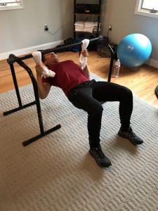 A man is doing chest press with bars