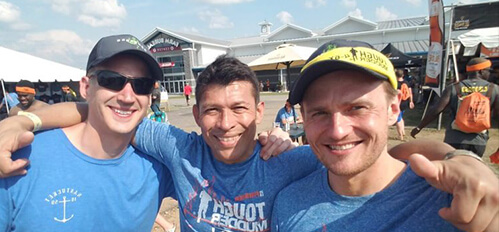 Three men are posing for a picture together.